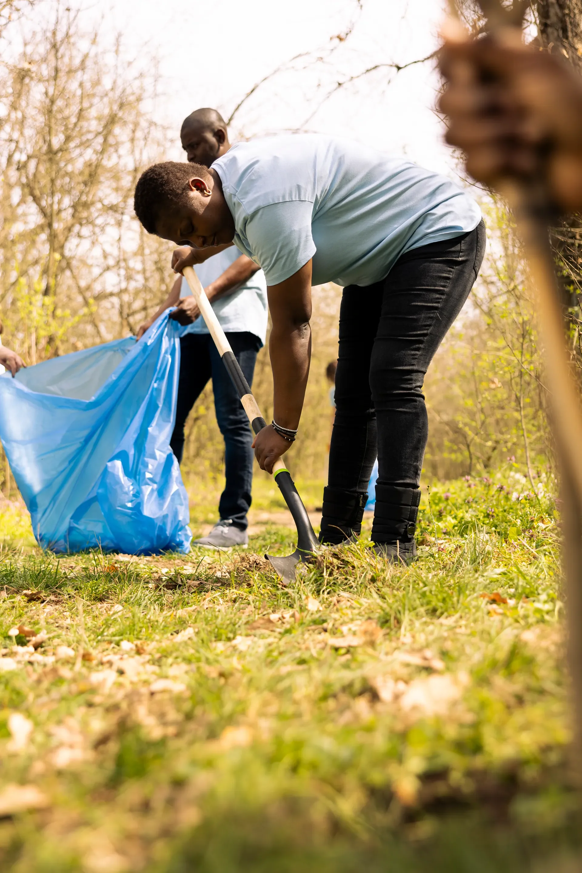 People using claw tools to collect garbage